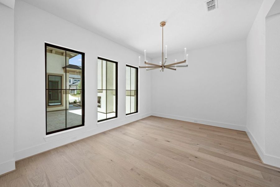 Sophisticated dining room overlooking the courtyard, creating an inviting setting for elegant dining and entertaining.