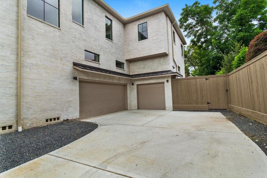 Three car garage and a lot of additional parking in the motor court located behind the automatic driveway gate