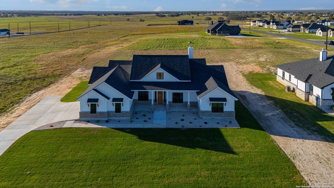 Front exterior of a new home in , La Vernia, TX, highlighting curb appeal (Image 27).