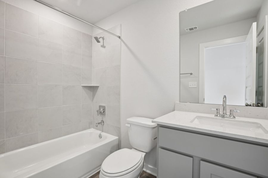 A bathroom with a tub toilet and sink.