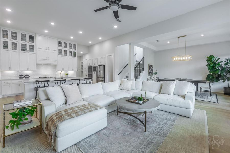 The spacious family room offers abundant seating space while remaining open to the kitchen and dining area. Its open-concept design creates a beautiful setting for entertaining on any scale. The spacious family room offers abundant seating space while remaining open to the kitchen and dining area. Its open-concept design creates a beautiful setting for entertaining on any scale.
