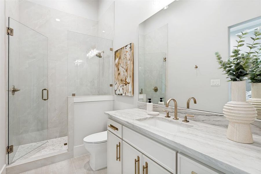 Guest suite with an en suite bath with spacious vanity and large walk in shower.