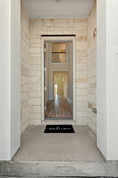 Property entrance featuring stone siding