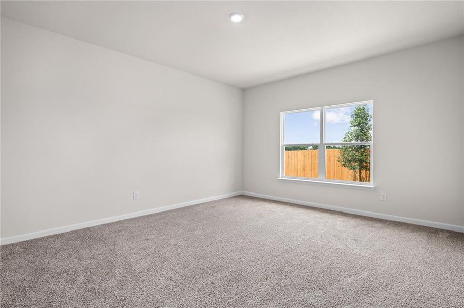 Carpeted spare room featuring baseboards and recessed lighting