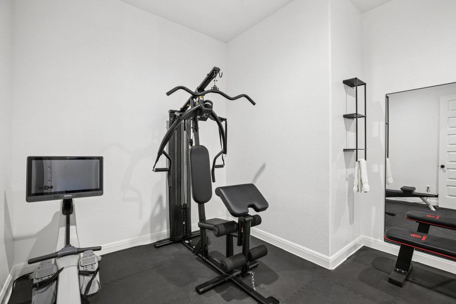 The primary suite includes a dedicated workout room that intelligently connects directly to the laundry center.