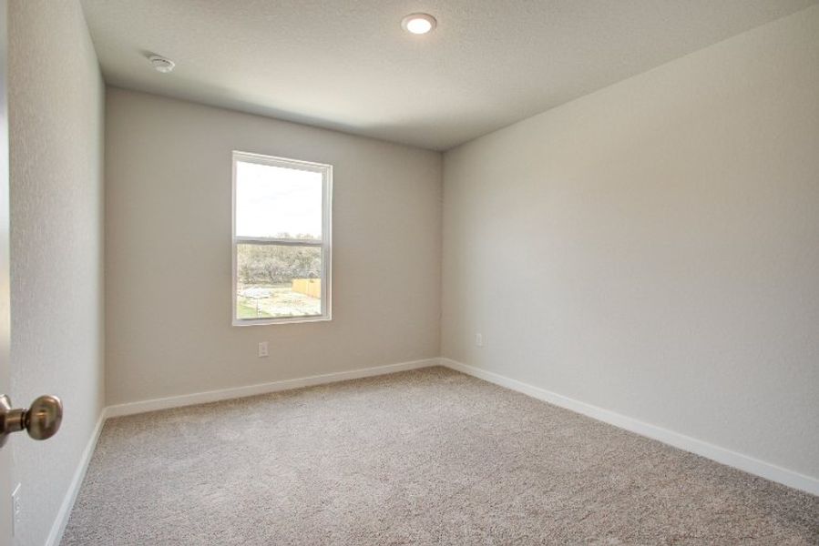 A room with a window and carpet. A room with a window and carpet.