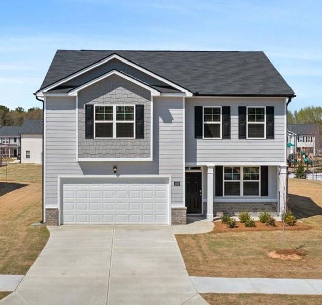 Front exterior of a new home in Champion's Run, Lithonia, GA, highlighting curb appeal (Image 1).