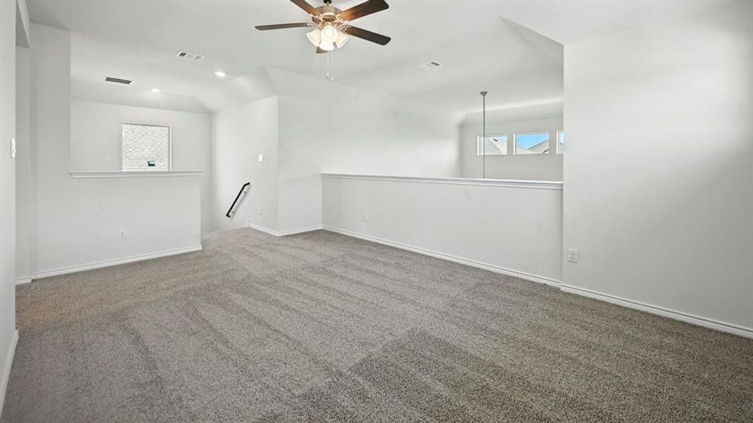 Spare room featuring dark colored carpet, a ceiling fan, and recessed lighting