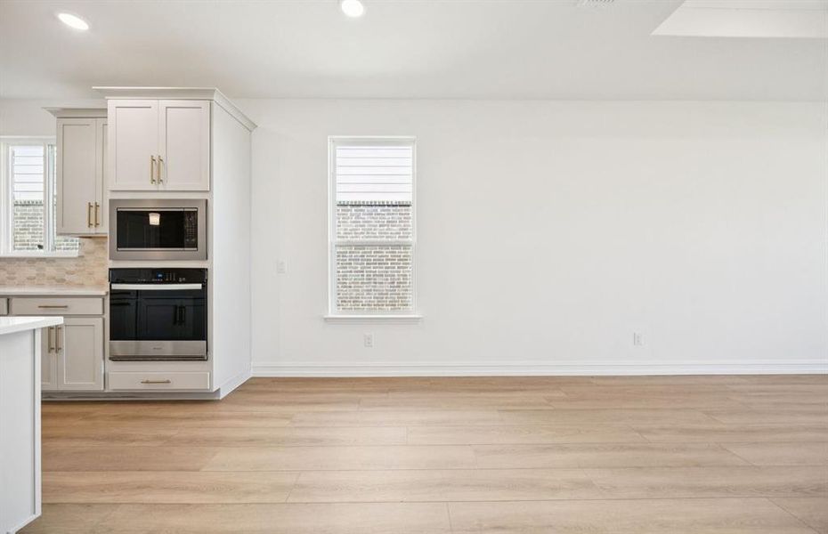 Dining nook off kitchen with large windows
