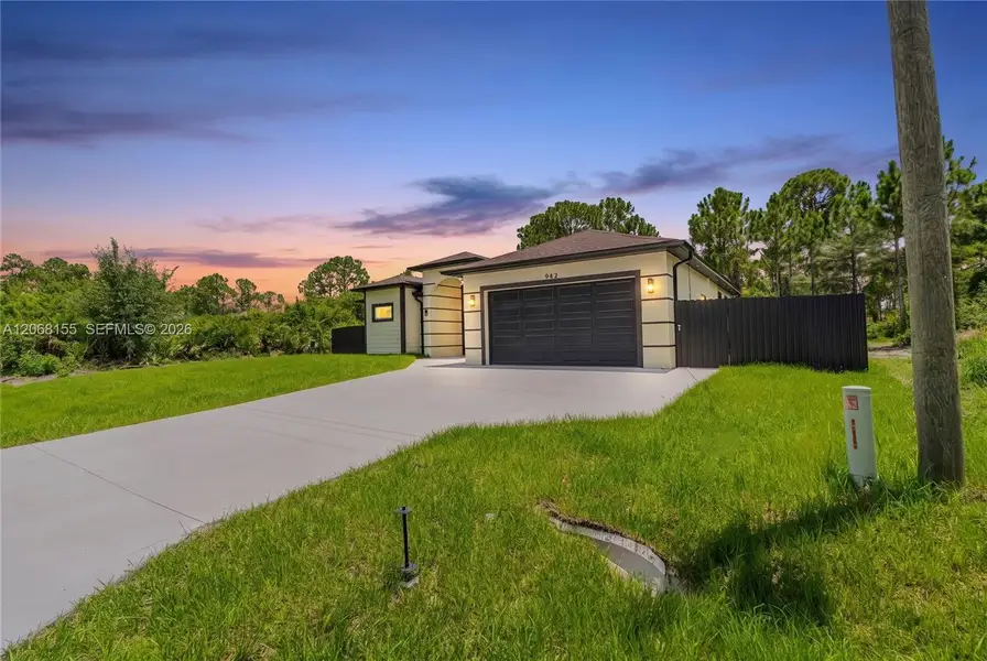 Front exterior of a new home in , Lehigh Acres, FL, highlighting curb appeal (Image 22). Front exterior of a new home in , Lehigh Acres, FL, highlighting curb appeal (Image 22).
