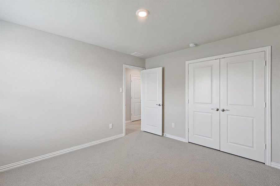 Unfurnished bedroom with a closet and carpet floors