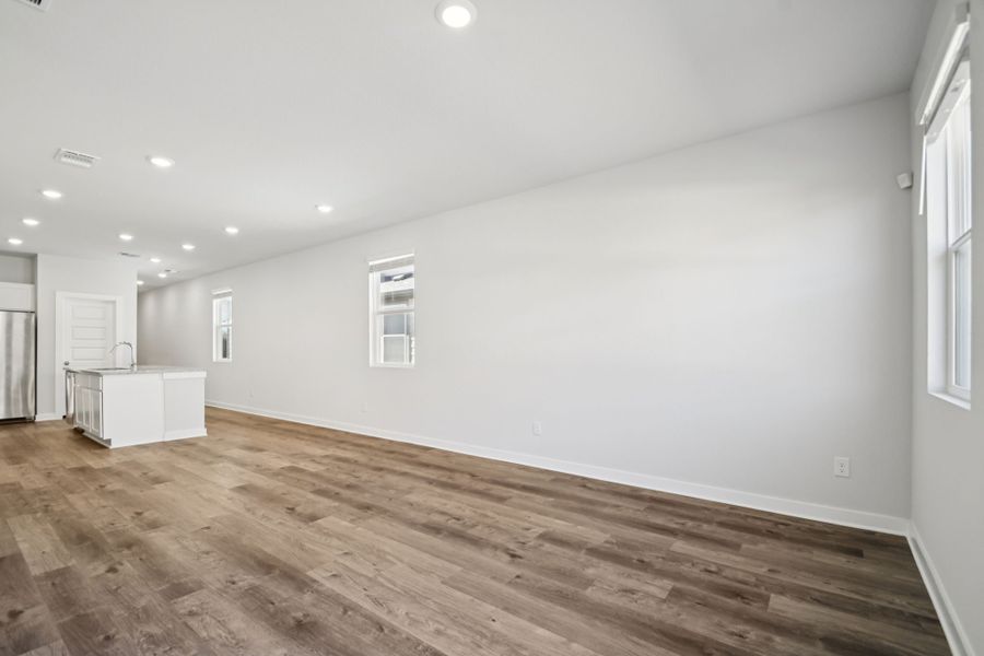 A room with a wood floor and white walls.