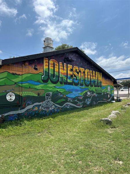 View of home's community with a yard