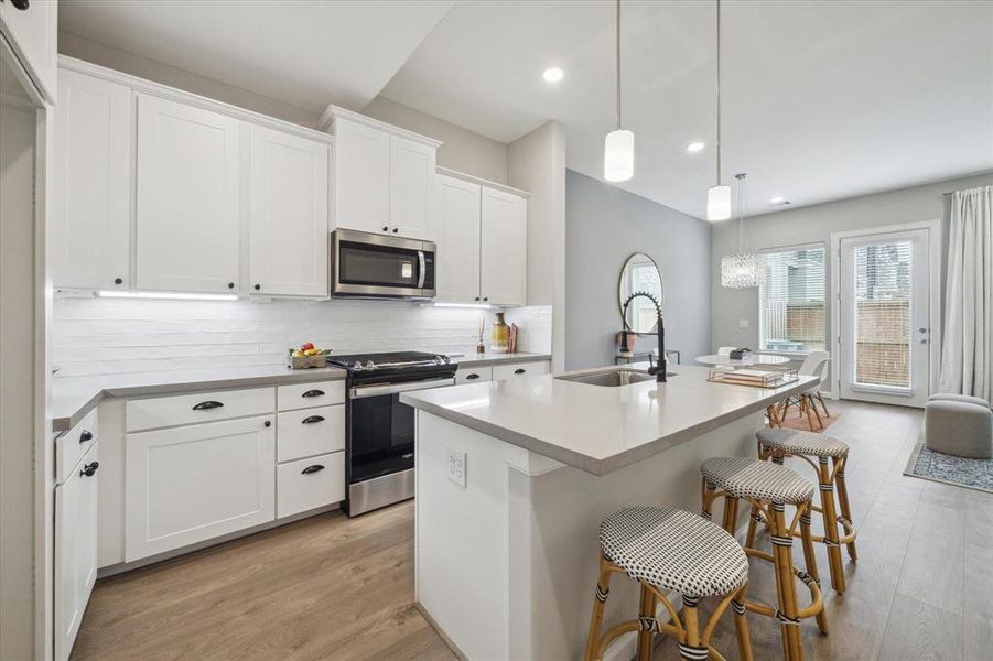 A view of the kitchen as seen fromthe garage entry area.