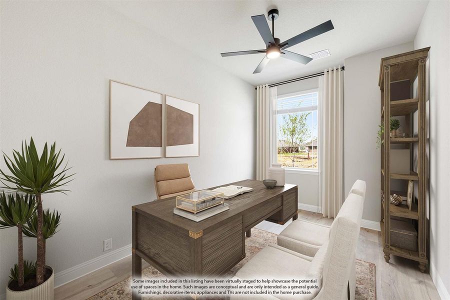 Home office with wood desk, ceiling fan, light wood floors, and a window with white curtains
