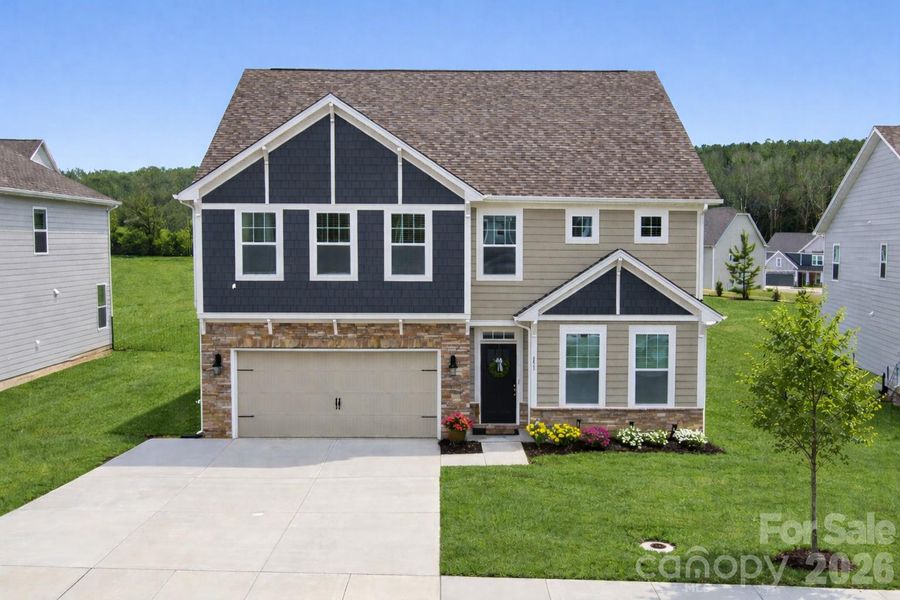 Attractive curb appeal highlighted by a widened driveway for extra vehicle space. (Virtually enhanced)