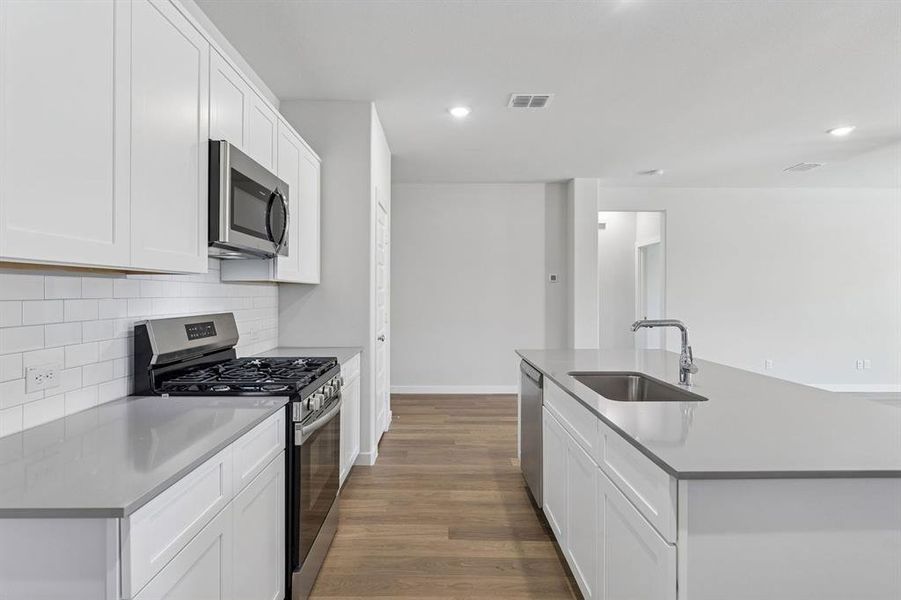 Kitchen in the Harrison home plan by Trophy Signature Homes – REPRESENTATIVE PHOTO