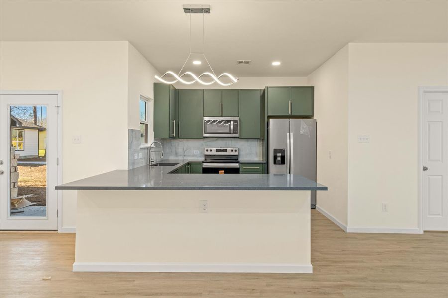 Spacious kitchen island anchors the heart of the home—perfect for hosting.