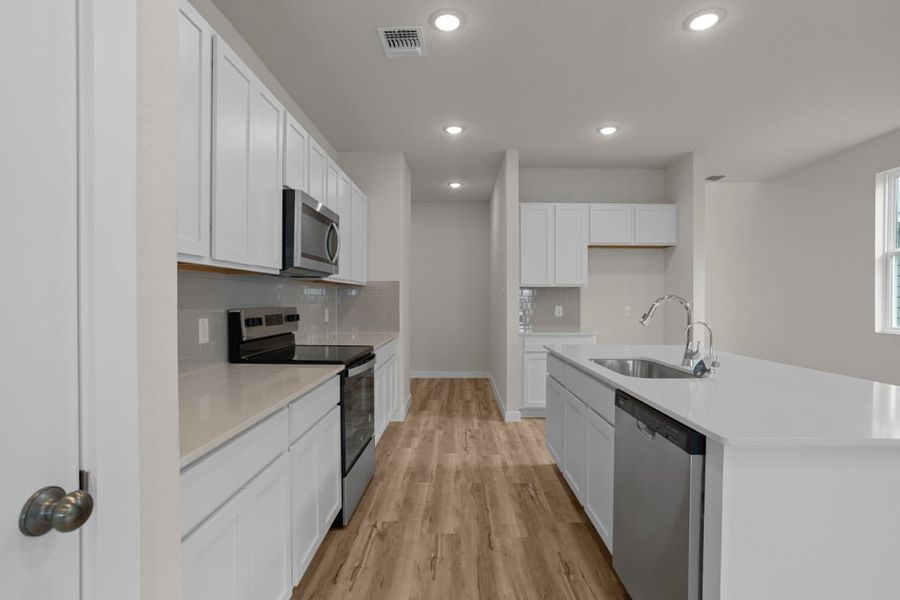 A kitchen with white cabinets. A kitchen with white cabinets.