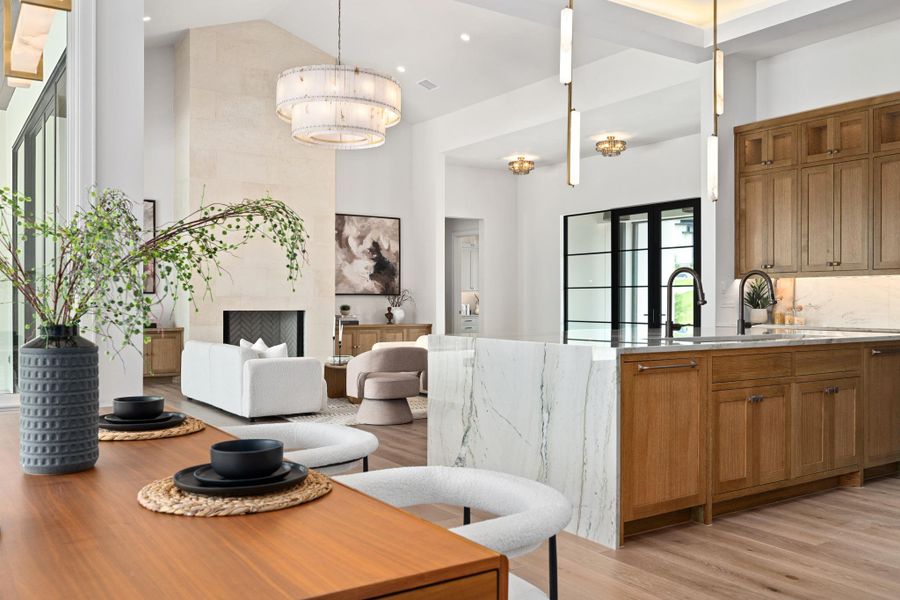 An open concept design seamlessly merges living, dining, and kitchen spaces, ideal for entertaining.