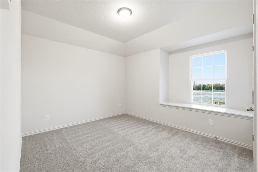 Carpeted empty room with baseboards