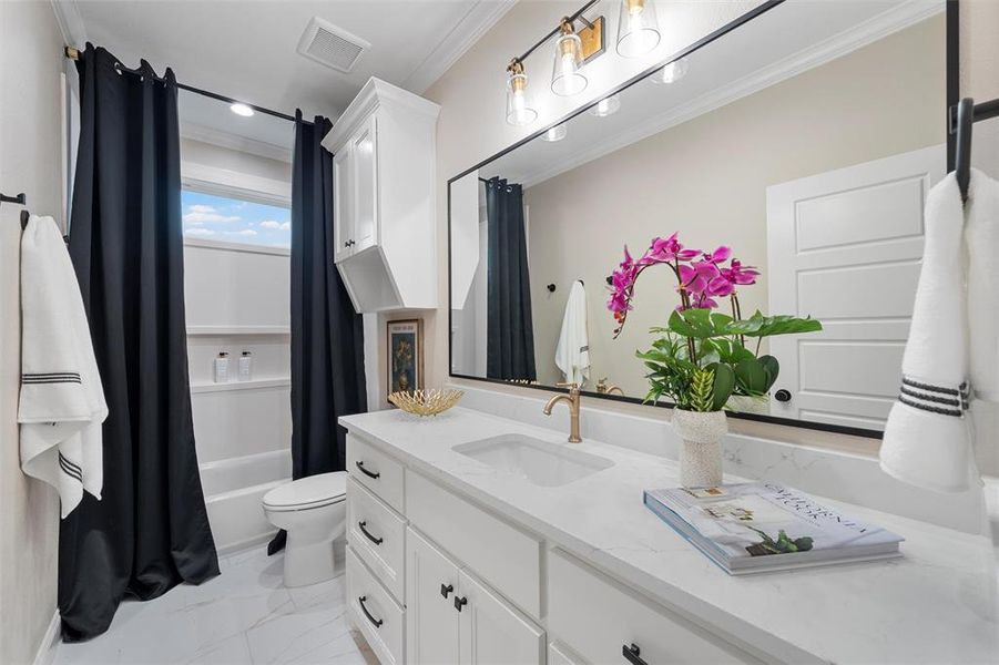 Full bathroom with visible vents, vanity, toilet, marble finish floor, and ornamental molding