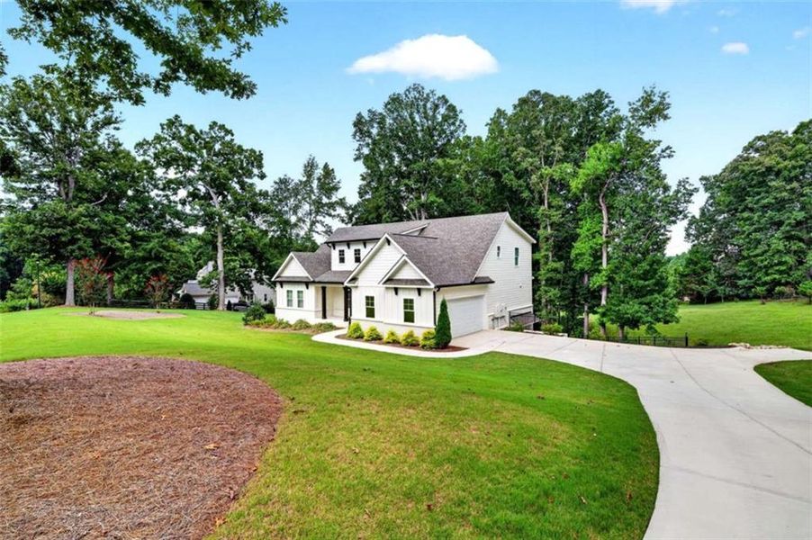 Front exterior of a new home in , Hoschton, GA, highlighting curb appeal (Image 26).