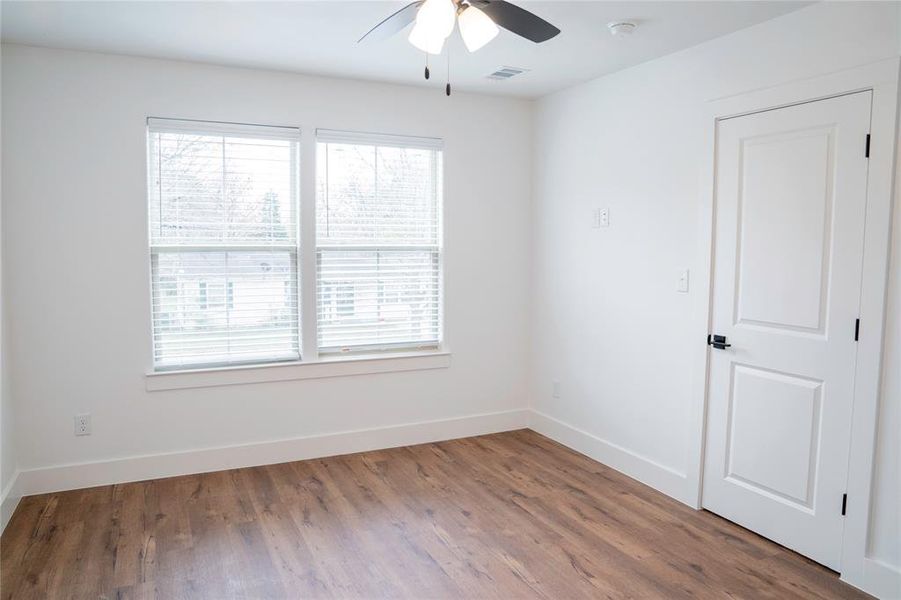 Unfurnished room with hardwood / wood-style floors and ceiling fan