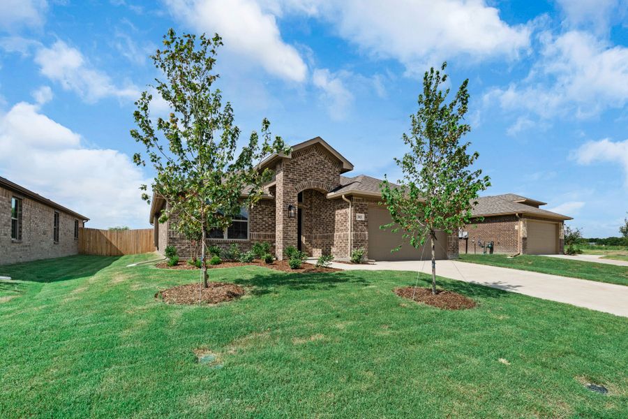 Front exterior of a new home in Fox Landing, Caddo Mills, TX, highlighting curb appeal (Image 17). Front exterior of a new home in Fox Landing, Caddo Mills, TX, highlighting curb appeal (Image 17).