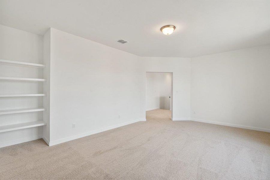 Unfurnished bedroom with light colored carpet