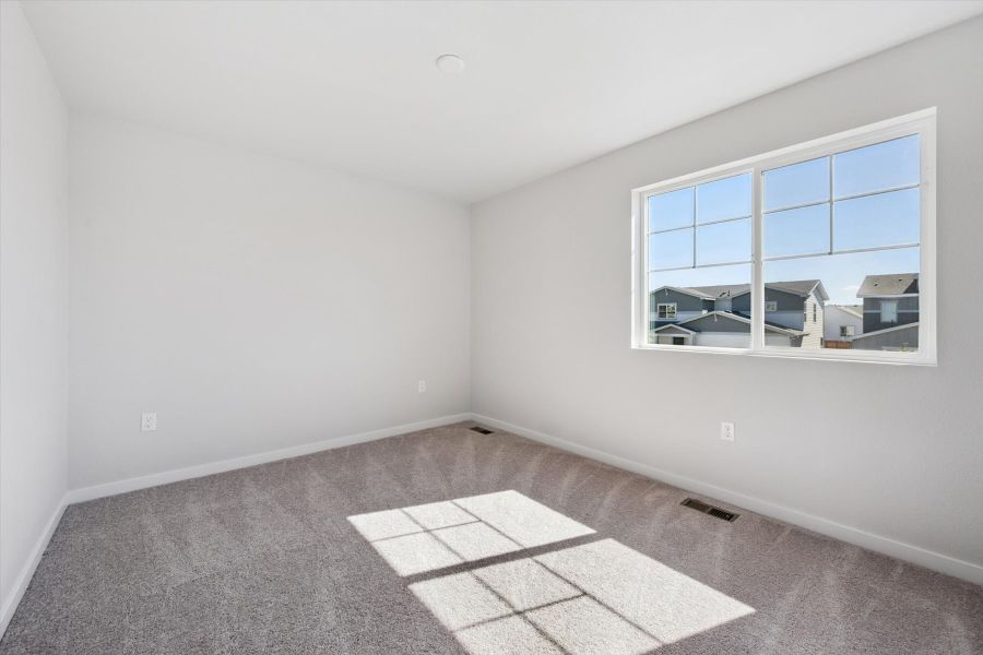 A room with a window and a tile floor. A room with a window and a tile floor.