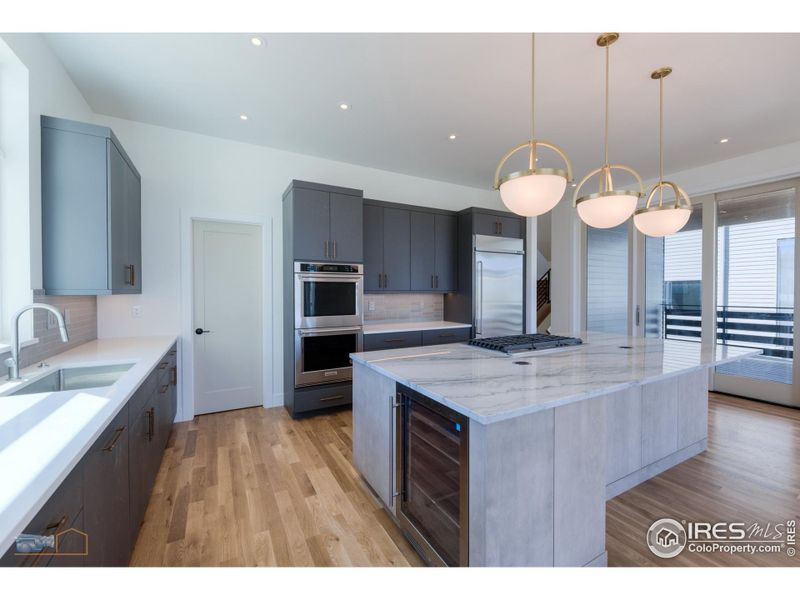 Gourmet Kitchen Features A Built In Refrigerator, Gas Cooktop With Downdraft, Double Wall Oven, Dishwasher, Microwave And Beverage Fridge