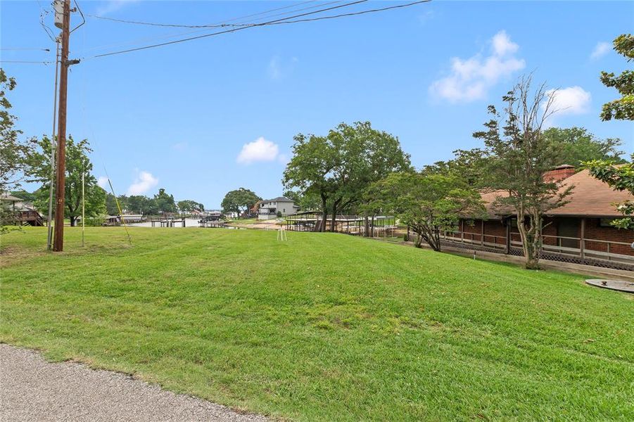 Spacious additional lot offering room for a guest house, covered parking, or personalized outdoor retreat (as allowed per deed restrictions and city zoning requirements)—flexibility for your lake lifestyle.