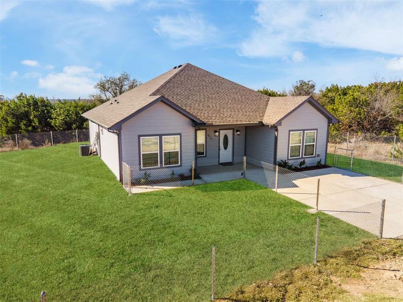 Ranch-style house with cooling unit and a front yard