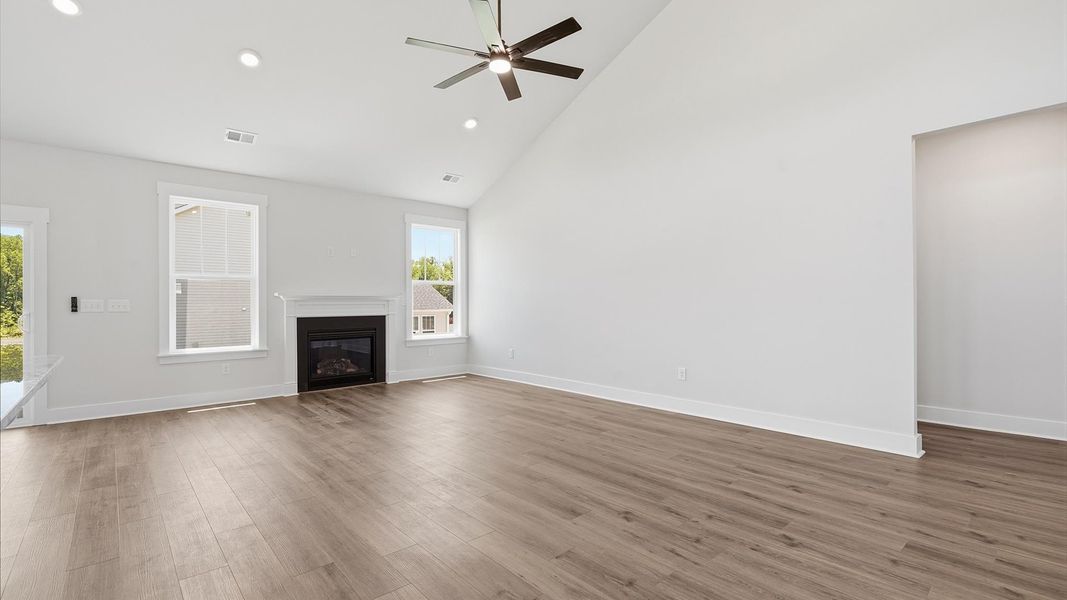 Vibrant family room with high-impact two-story ceilings and thoughtful layout for entertaining Vibrant family room with high-impact two-story ceilings and thoughtful layout for entertaining