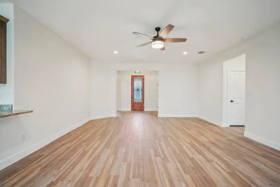Unfurnished room featuring visible vents, baseboards, ceiling fan, recessed lighting, and light wood-style flooring