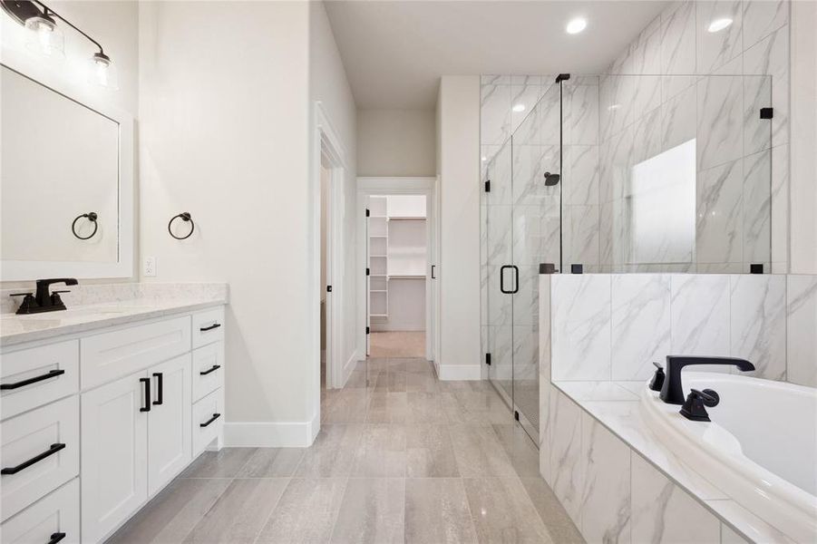 Bathroom with vanity and shower with separate bathtub