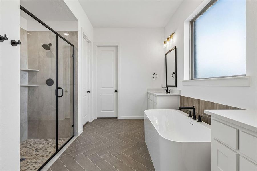You'll enjoy a spacious walk in shower plus a luxurious free standing tub in this dream owner's bath!