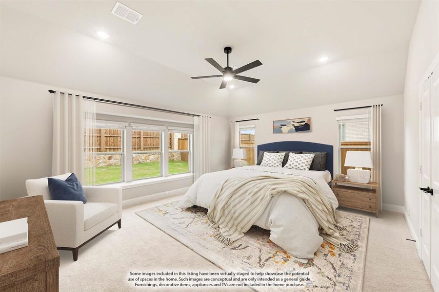 Spacious bedroom with vaulted ceiling, ceiling fan, carpet flooring, and large windows overlooking a backyard. Spacious bedroom with vaulted ceiling, ceiling fan, carpet flooring, and large windows overlooking a backyard.