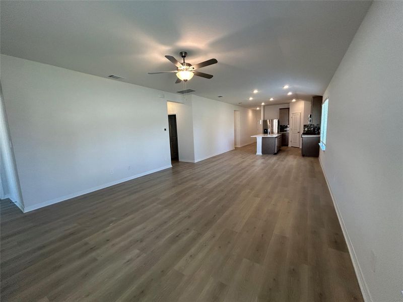 Unfurnished living room with dark wood-type flooring, recessed lighting, and a ceiling fan