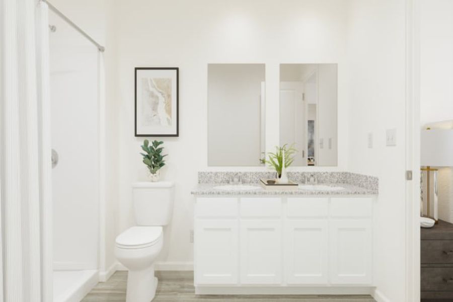 A bathroom with a sink toilet and a plant.