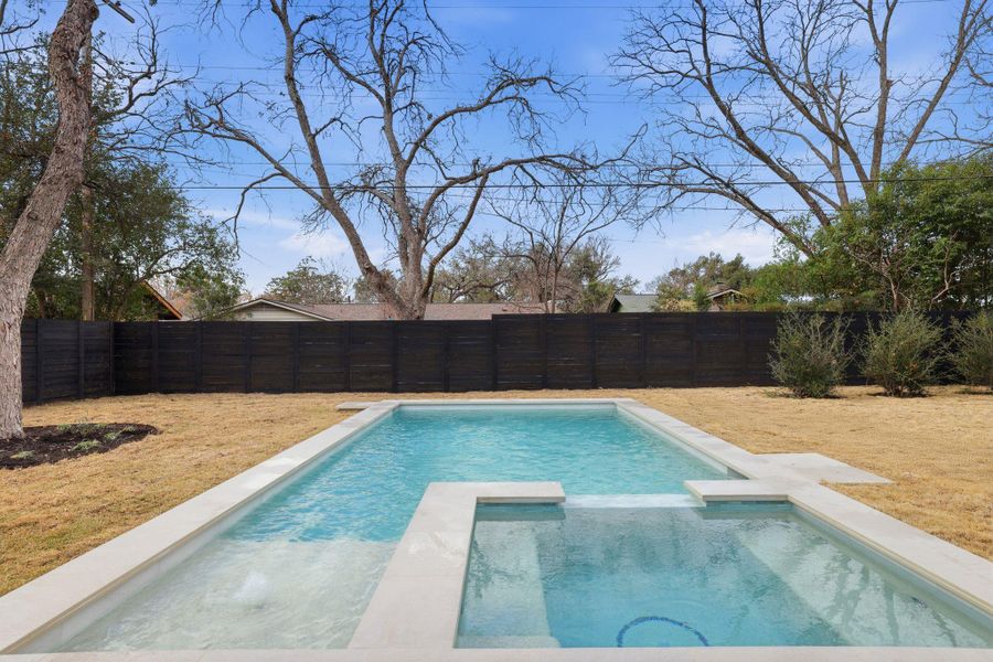 Relaxing pool / spa featuring a fenced backyard