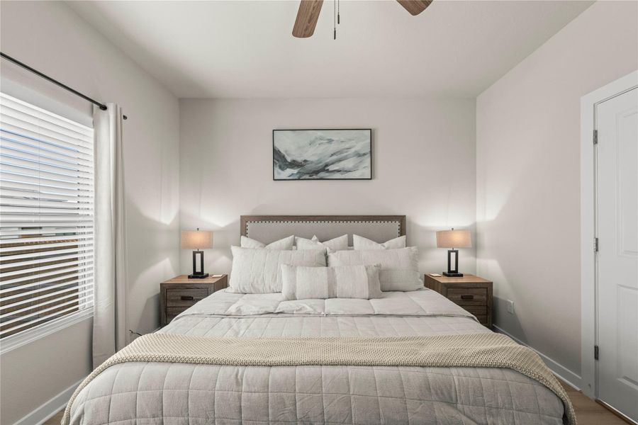 Well-lit and tranquil, this bedroom provides a serene retreat for relaxation. Well-lit and tranquil, this bedroom provides a serene retreat for relaxation.