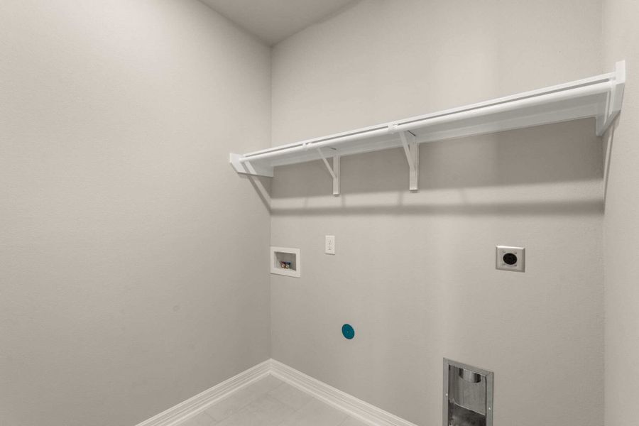 The utility room features tile flooring and shelving