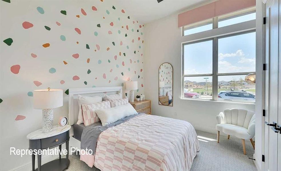 Bright room featuring a large multi-pane window, high ceilings, and light-colored carpeting