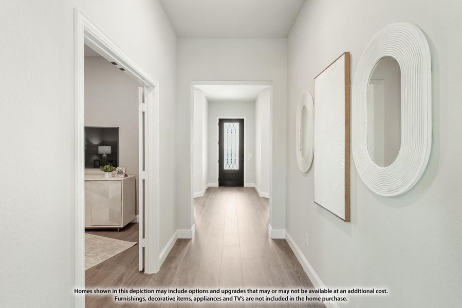 Bright entryway hallway with light wood floors, white walls, and a dark front door with glass panels Bright entryway hallway with light wood floors, white walls, and a dark front door with glass panels