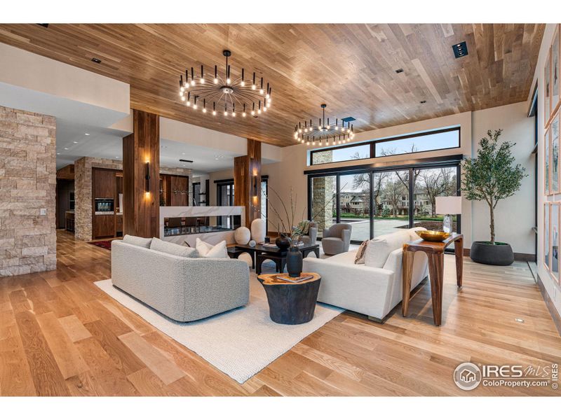 The large living room includes a 4 panel sliding door that opens to the south facing backyard with pool, spa, pool house and a 2,500+ square feet sandstone-washed patio for relaxing and entertaining.