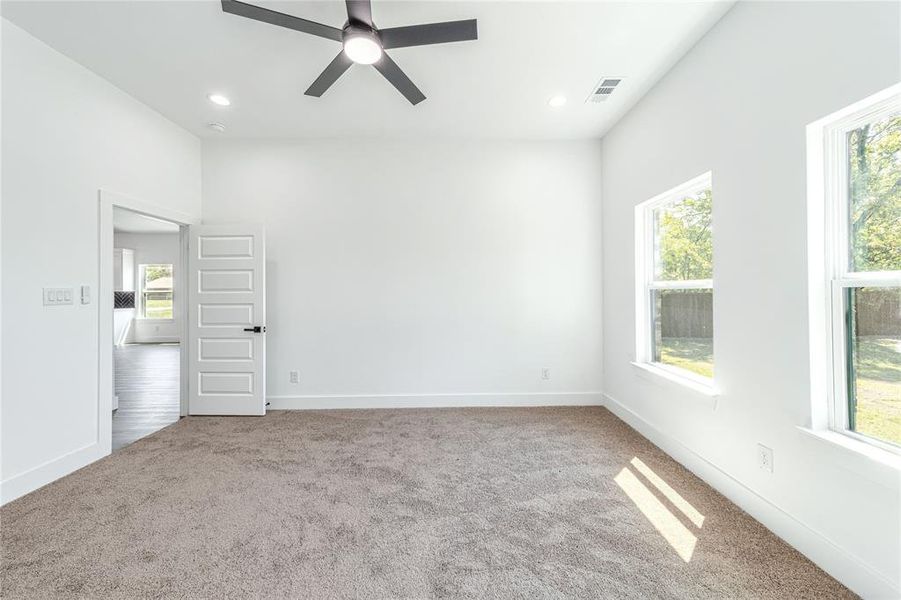Room featuring light colored carpet, a ceiling fan, and recessed lighting