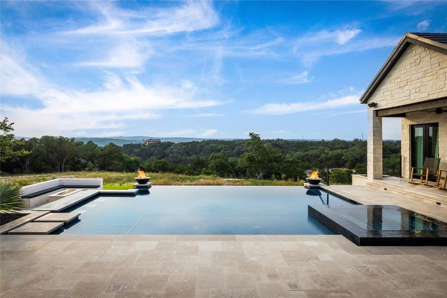 View of pool with an in ground hot tub, an outdoor fire pit, and a patio area