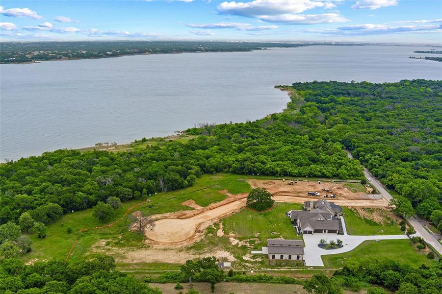 Expansive property featuring a waterfront setting, substantial wooded areas, and a paved private drive Expansive property featuring a waterfront setting, substantial wooded areas, and a paved private drive